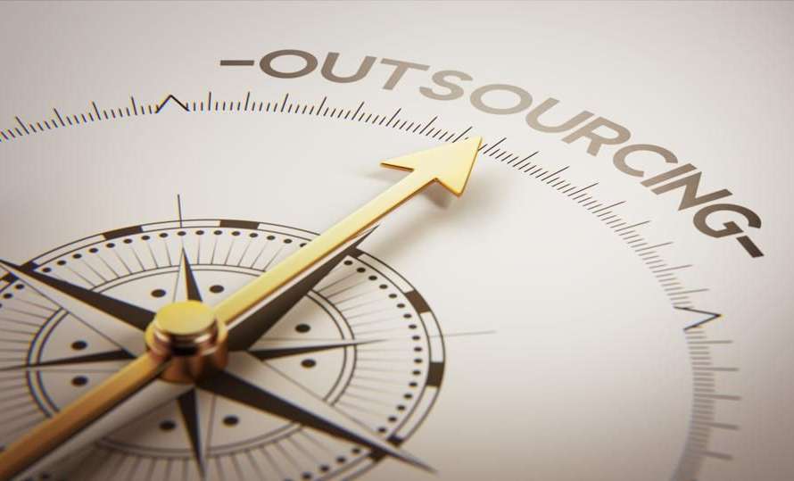 Philippine outsourcing professionals working in a modern office with laptops